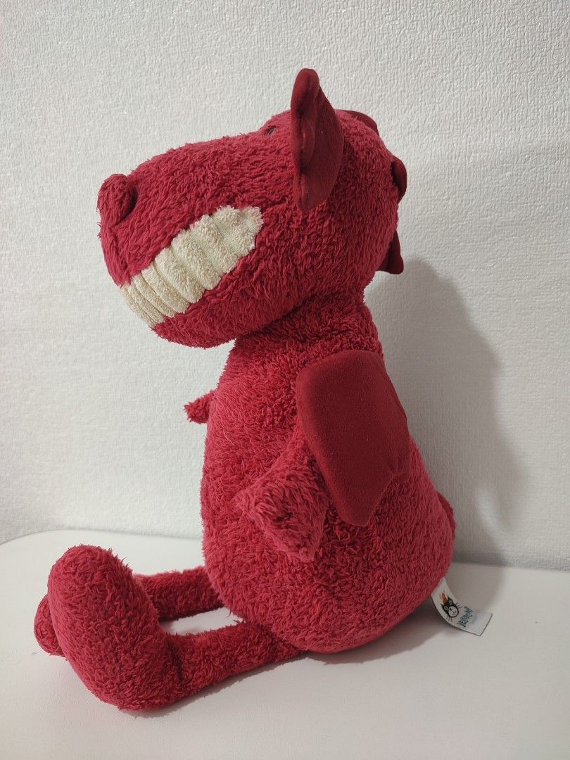 Jellycat Red Dragon Soft Toy (Category: Plushies & Soft Toys) located in Manila. Submitted by epicmountain-f20453 (Listing ID 1469116152, Image 2). Description: - Brand: Jellycat London - Character: Bright red plush dragon - Condition: Brand new with tag attached - Size: Standard medium plush - Features: Textured fur, fabric wings, and a wide smiling face with white teeth - Ideal for: Jellycat collectors, kids, and gifting.