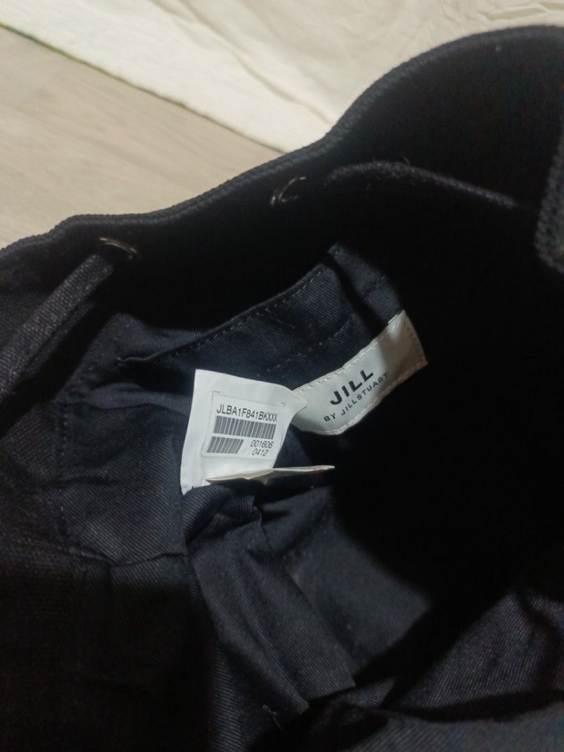 Jill by Jillstuart Black Canvas Bucket Bag (Category: Shoulder Bags) located in Digos. Submitted by jenepiisid83759 (Listing ID 1469020295, Image 2). Description: - Brand: Jill by Jillstuart - Material: Durable black canvas - Design: White embroidered logo across the front with metal eyelets - Closure: Drawstring closure - Strap: Adjustable for comfortable wear - Interior: Fabric-lined with brand tag and product code label intact - Condition: Exc
