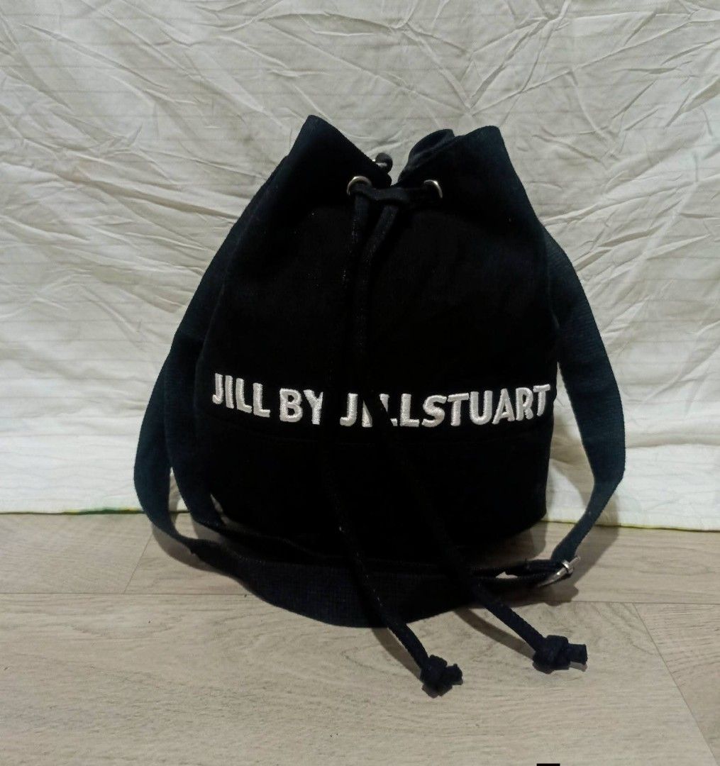Jill by Jillstuart Black Canvas Bucket Bag (Category: Shoulder Bags) located in Digos. Submitted by jenepiisid83759 (Listing ID 1469020295, Image 1). Description: - Brand: Jill by Jillstuart - Material: Durable black canvas - Design: White embroidered logo across the front with metal eyelets - Closure: Drawstring closure - Strap: Adjustable for comfortable wear - Interior: Fabric-lined with brand tag and product code label intact - Condition: Exc