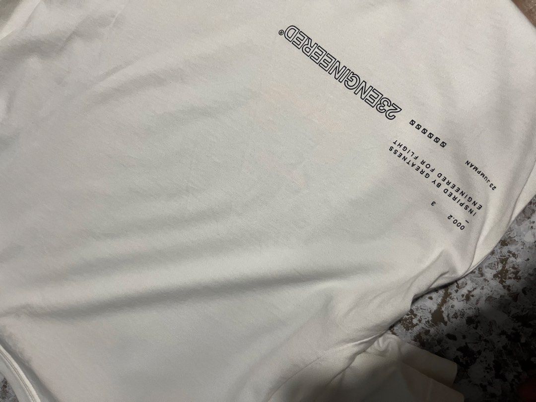 Jordan 23 Engineered White T-Shirt (Category: Tshirts & Polo Shirts ) located in Maasin. Submitted by niconii090 (Listing ID 1468986162, Image 3). Description: - Brand/Model: Jordan 23 Engineered t-shirt - Color: White with orange graphic print and back text details - 📏 21 x 26 (inches) - Condition: Great streetwear staple, clean neckline, material tags intact inside collar - Styling: Easy to pair with shorts or denim.