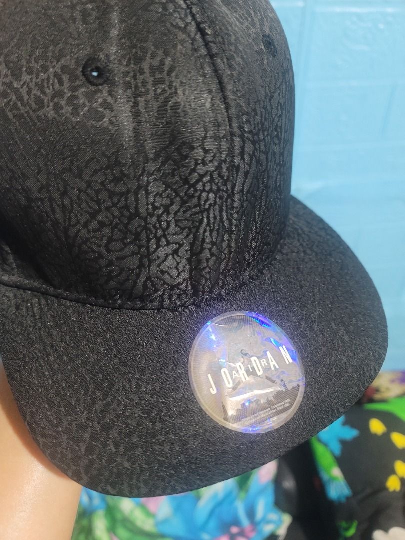 Jordan Black Elephant Print Snapback Cap Hat (Category: Caps & Hats) located in Caloocan City. Submitted by remwil18 (Listing ID 1468933633, Image 2). Description: - Authentic Jordan snapback cap in classic black - Iconic all-over elephant print texture - Embroidered white Jumpman logo on the side - Original hologram sticker still attached to the flat brim - Adjustable snapback closure for a custom fit - Verified style code HO160508ASH on inner t