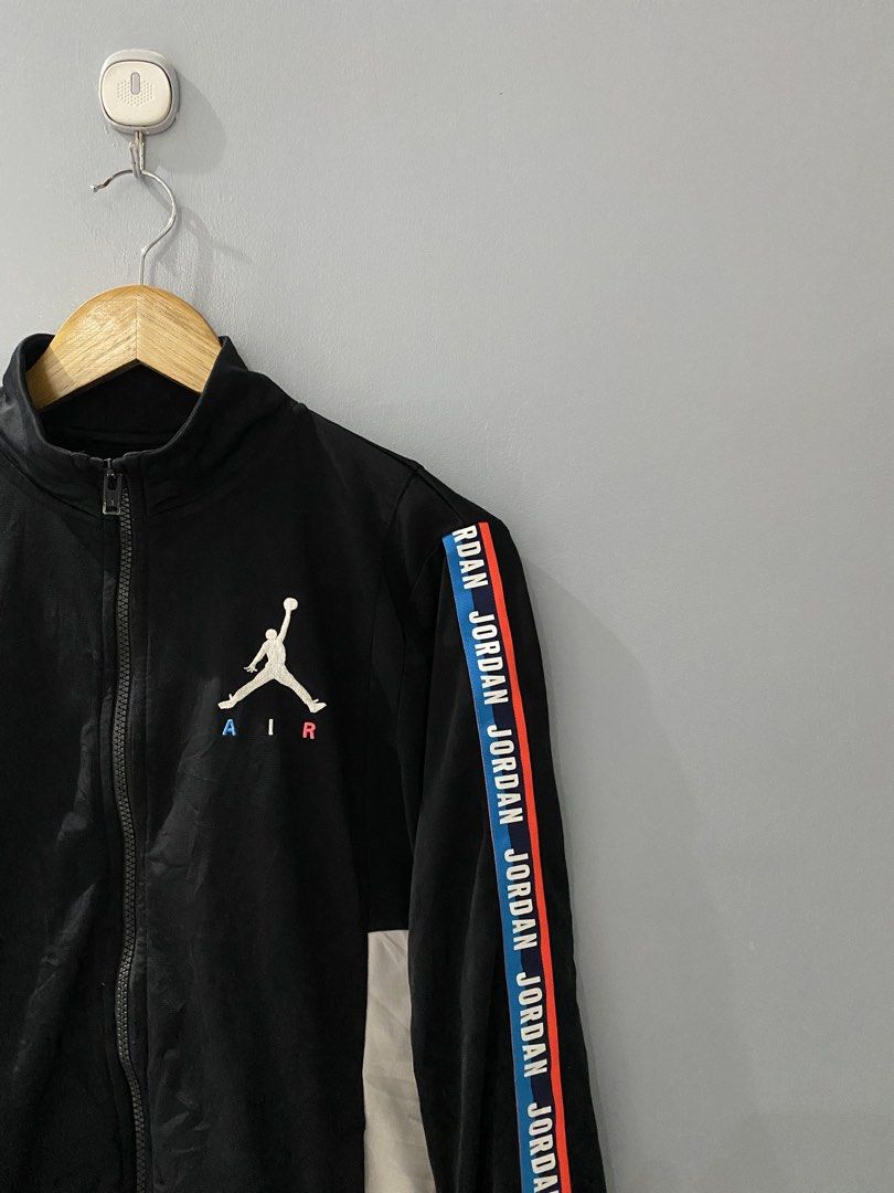 Jordan Black Track Jacket Youth XL (Category: Coats, Jackets and Outerwear) located in Bangued. Submitted by koroysthrifts (Listing ID 1469073082, Image 1). Description: - Brand: Jordan 20x25 - Color: Black with white side panels and branded tape - Details: Embroidered Jumpman logo with blue and red Air text, full zip, high collar, ribbed cuffs and hem - Size: Youth XL (fits ages 13-15 years / height 158-170 cm) - Material: Polyester (Made in Ind