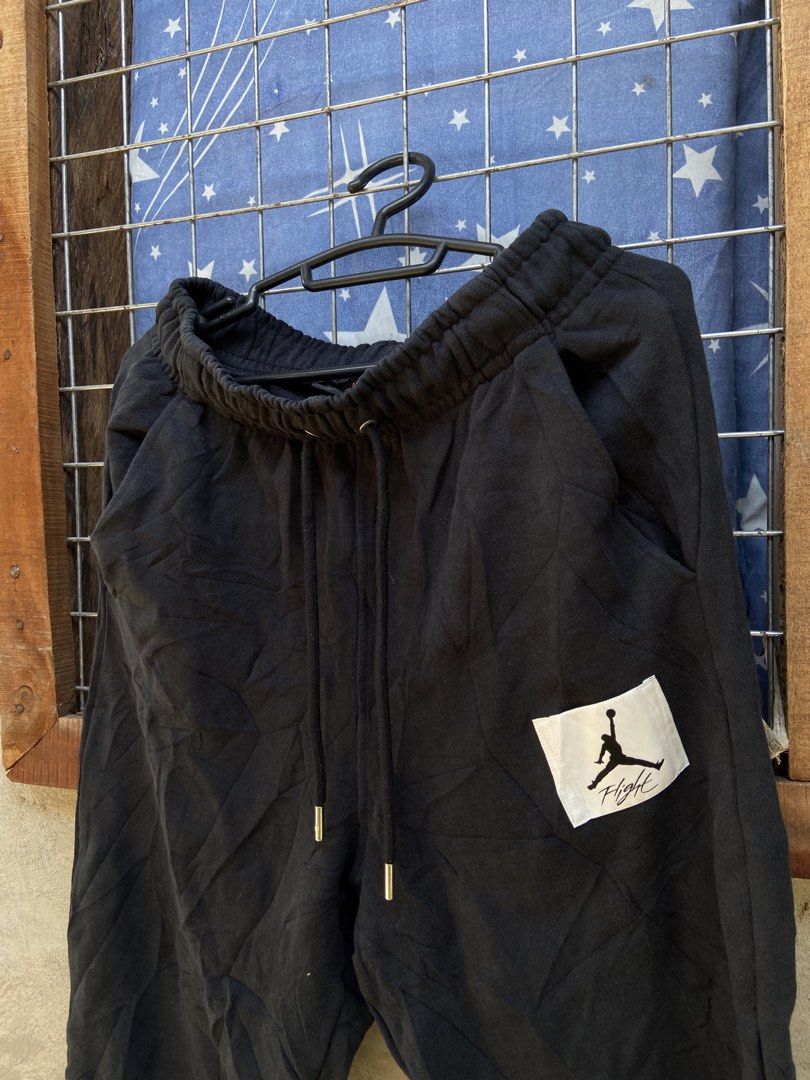 Jordan Flight Black Sweatpants (Category: Joggers) located in Cagayan de Oro. Submitted by mindanao_thrifters (Listing ID 1468944508, Image 2). Description: - Color: Black - Brand: Jordan (Est. 1985) - Fit: Standard lounge fit - Features: Elastic waistband with adjustable drawstring and metal aglets - Details: Distinctive Flight patch logo on the left thigh - Pockets: Two functional side pockets - Hem: Cuffed ankles - Origin: Made in China - Styl