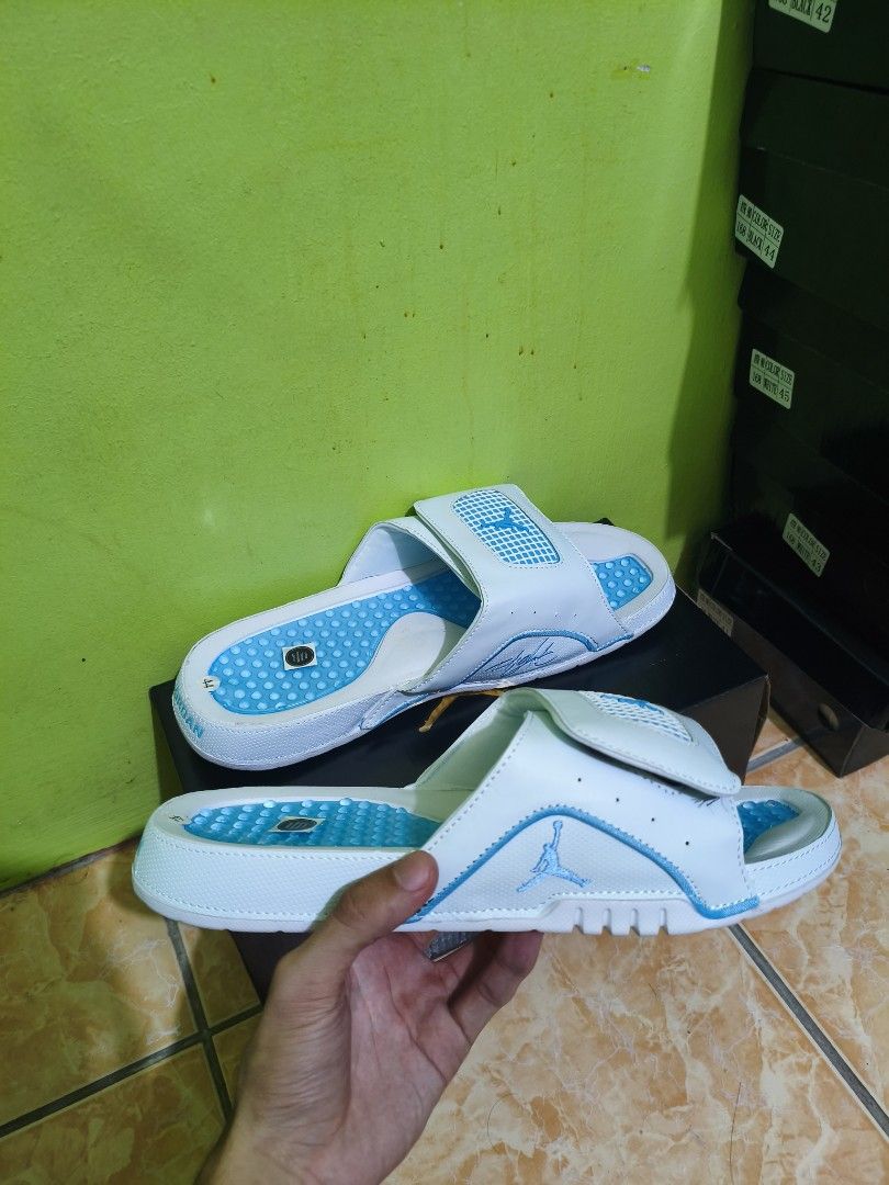 Jordan Slide Sandals Multiple Colors Available (Category: Slippers & Slides) located in Manila. Submitted by eugeneamb94806 (Listing ID 1469133135, Image 1). Description: - Authentic Jordan slide sandals for casual wear and daily errands - Features a textured footbed for extra grip and a lightweight build - Adjustable top strap with iconic Jumpman logo - Thick sole with reliable traction - Available colors: White and Blue, Silver Glitter, Black, 