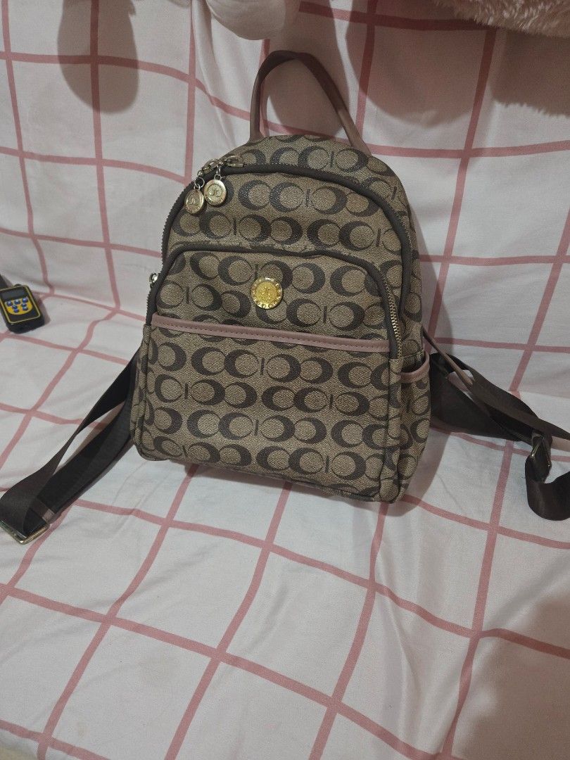 Jovanni C design bagpack (almost coach dupe) (Category: Backpacks) located in Manila. Submitted by misushoppa (Listing ID 1469027001, Image 1). Description: 🎀 Original price: ₱2,500 Condition: 9.5/10 (almost new!) no issue with many compartments color: pink & brown Decluttering one of my favorite bags! 🥹💕 Limited-edition design na hindi na available ngayon sa store. Maganda siya in person, and honestly, maraming friends na ilang beses na itong
