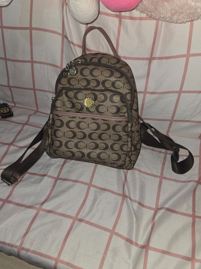 Jovanni C design bagpack (almost coach dupe) (Category: Backpacks) located in Manila. Submitted by misushoppa (Listing ID 1469027001, Image 2). Description: 🎀 Original price: ₱2,500 Condition: 9.5/10 (almost new!) no issue with many compartments color: pink & brown Decluttering one of my favorite bags! 🥹💕 Limited-edition design na hindi na available ngayon sa store. Maganda siya in person, and honestly, maraming friends na ilang beses na itong