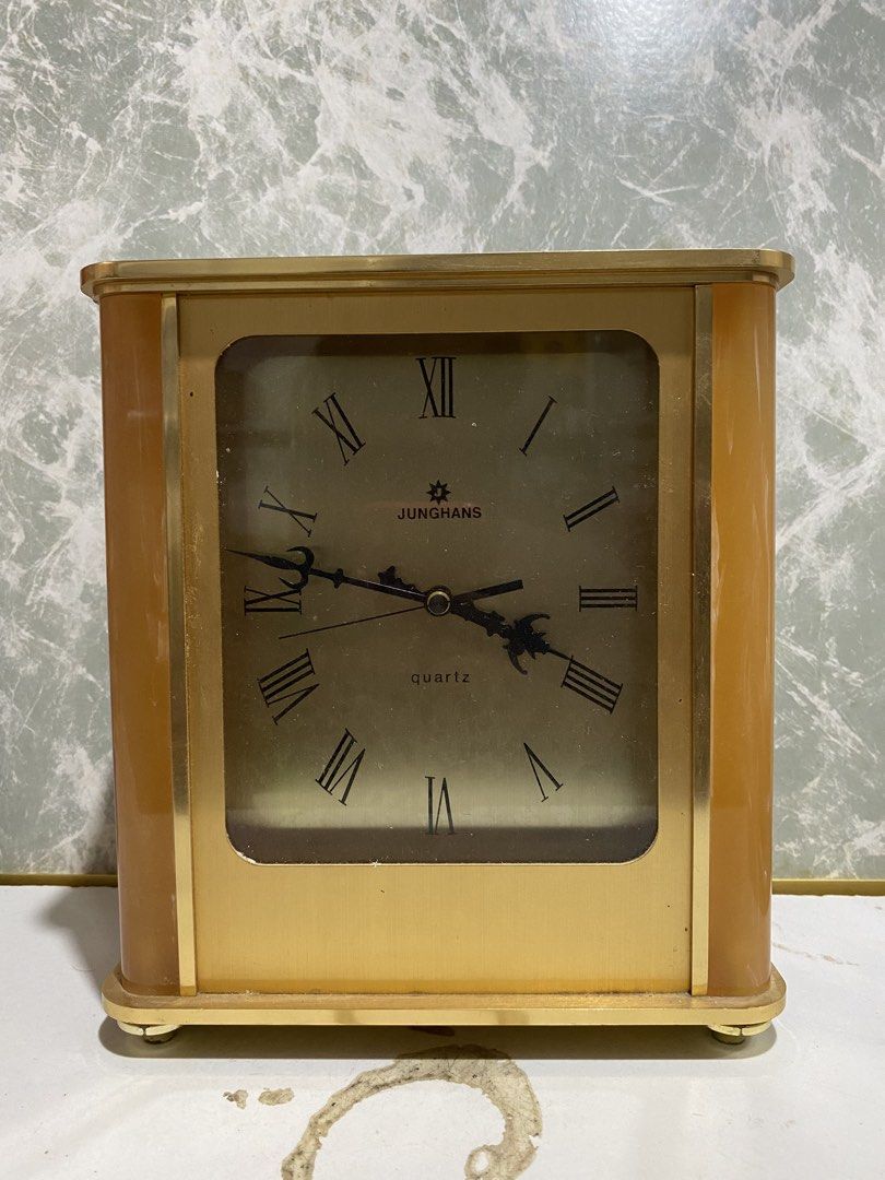 Junghans Quartz Mantel Clock Vintage Gold Tone (Category: Clocks) located in Calamba. Submitted by chebvintagedepot (Listing ID 1469036347, Image 1). Description: (B17-01) Vintage Junghans Astra quartz desk or mantle clock, likely dating from the 1970s–1980s. Made in Germany, it features a golden-tone brass finish with a resin or Lucite-style casing, black Roman numerals, and ornate hands. The clock has a classic vintage look, suitable for displa
