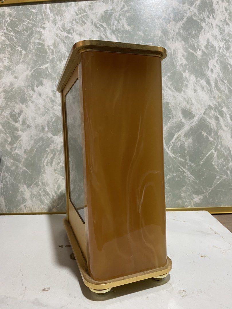 Junghans Quartz Mantel Clock Vintage Gold Tone (Category: Clocks) located in Calamba. Submitted by chebvintagedepot (Listing ID 1469036347, Image 3). Description: (B17-01) Vintage Junghans Astra quartz desk or mantle clock, likely dating from the 1970s–1980s. Made in Germany, it features a golden-tone brass finish with a resin or Lucite-style casing, black Roman numerals, and ornate hands. The clock has a classic vintage look, suitable for displa