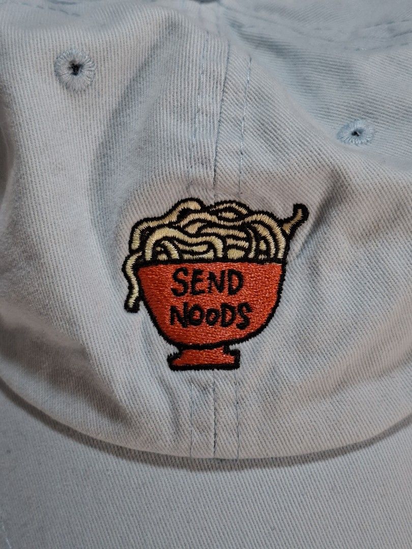 JV Send Noods Embroidered Pastel Blue Baseball Cap (Category: Caps & Hats) located in Baguio. Submitted by restyrille77846 (Listing ID 1469066038, Image 2). Description: - Color: Light blue - Design: Embroidered 'SEND NOODS' noodle bowl graphic on front - Fit: Adjustable strap with brass metal buckle - Details: JV tag near closure, six-panel design with breathable embroidered eyelets - Condition: Clean inside and out, perfect casual streetwear ac