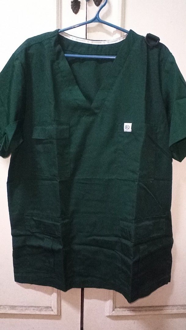 Kaizenph Green Scrub Set (Category: Sets or Coordinates) located in Caloocan City. Submitted by pcencarnacion1 (Listing ID 1469063950, Image 1). Description: - Brand: Kaizenph - Color: Dark green - Size: Large (tag visible inside collar) - Style: V-neck with chest and lower front pockets - Condition: Clean, neatly pressed, and ready for work.