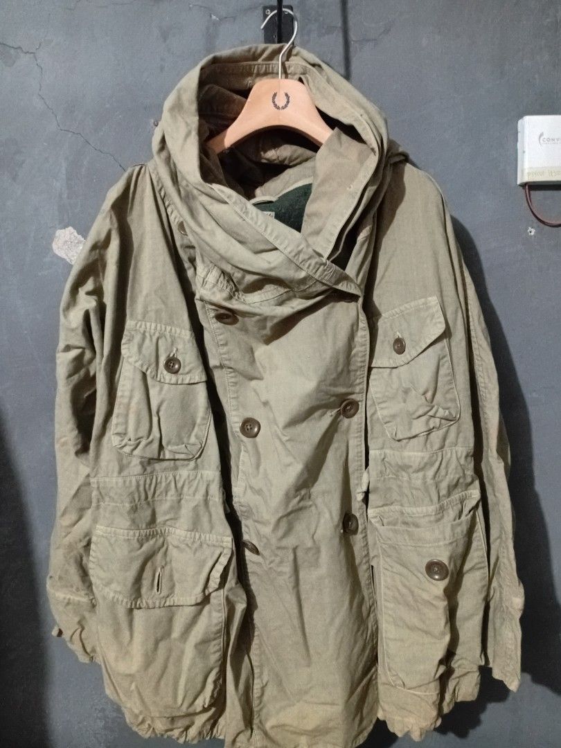 Kapital Katsuragi Ring Coat (Category: Coats, Jackets and Outerwear) located in Makati City. Submitted by homme.boy.plus (Listing ID 1469084029, Image 1). Description: - Authentic Kapital jacket sourced directly from Japan - Heavy-duty olive green utility fabric - Double-breasted button closure - Large hood lined with warm dark green fleece - Multiple front utility pockets - Rugged vintage workwear aesthetic - Made in Japan tag included.