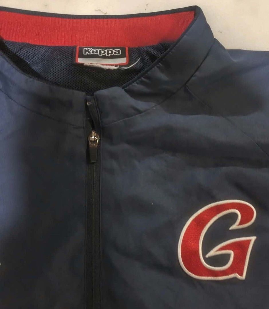 Kappa Navy Blue Red Short Sleeve Half Zip Jacket (Category: Coats, Jackets and Outerwear) located in San Carlos City. Submitted by dhong_abay_thrift (Listing ID 1468978554, Image 2). Description: - Brand: Kappa - Color: Navy blue and red - Style: Short sleeve half-zip jacket with high red collar - Details: Large embroidered 'G' on the chest, classic Kappa logo on the right side - Material: Lightweight and comfortable - Extra Feature: Zippered bot