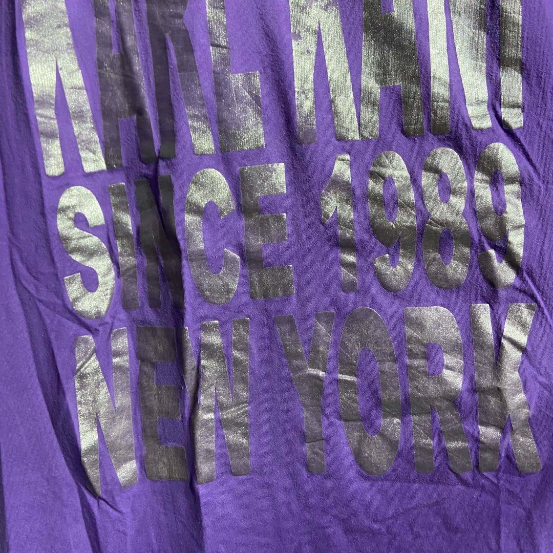 Karl Kani Purple Graphic Tee (Category: Shirts) located in Roxas City. Submitted by vaultcultureco. (Listing ID 1469094077, Image 3). Description: - Brand: Karl Kani - Size: XL - Color: Purple with large silver foil front lettering (Since 1989 New York) - Material: 100% Cotton - Fit/Style: Short sleeves, crew neckline, casual streetwear - Condition: Excellent.