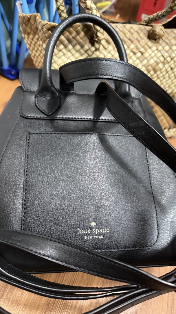 Kate Spade New York Black Leather Backpack (Category: Backpacks) located in Valenzuela. Submitted by ruichi080607 (Listing ID 1468982474, Image 2). Description: Black leather backpack from Kate Spade New York. Flap closure with silver-tone spade lock hardware. Top handle and adjustable shoulder straps. Exterior slip pocket on the back. Cream fabric lining with spade jacquard pattern inside, zippered pocket, and inner tag. Structured shape, classi