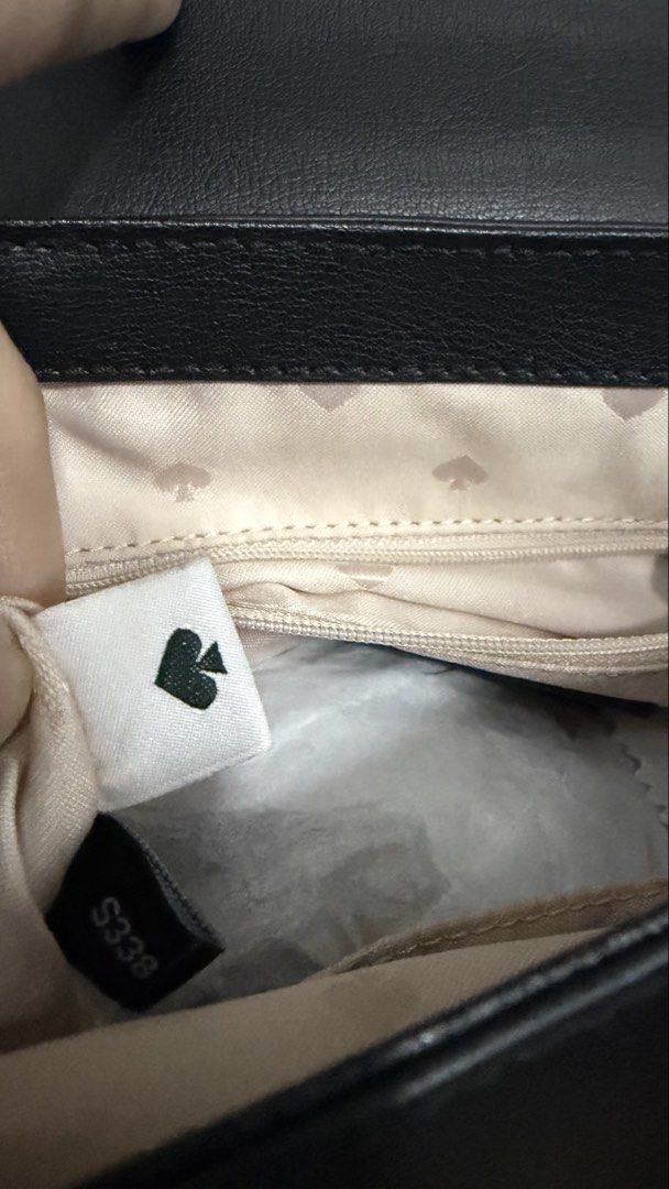 Kate Spade New York Black Leather Backpack (Category: Backpacks) located in Valenzuela. Submitted by ruichi080607 (Listing ID 1468982474, Image 3). Description: Black leather backpack from Kate Spade New York. Flap closure with silver-tone spade lock hardware. Top handle and adjustable shoulder straps. Exterior slip pocket on the back. Cream fabric lining with spade jacquard pattern inside, zippered pocket, and inner tag. Structured shape, classi