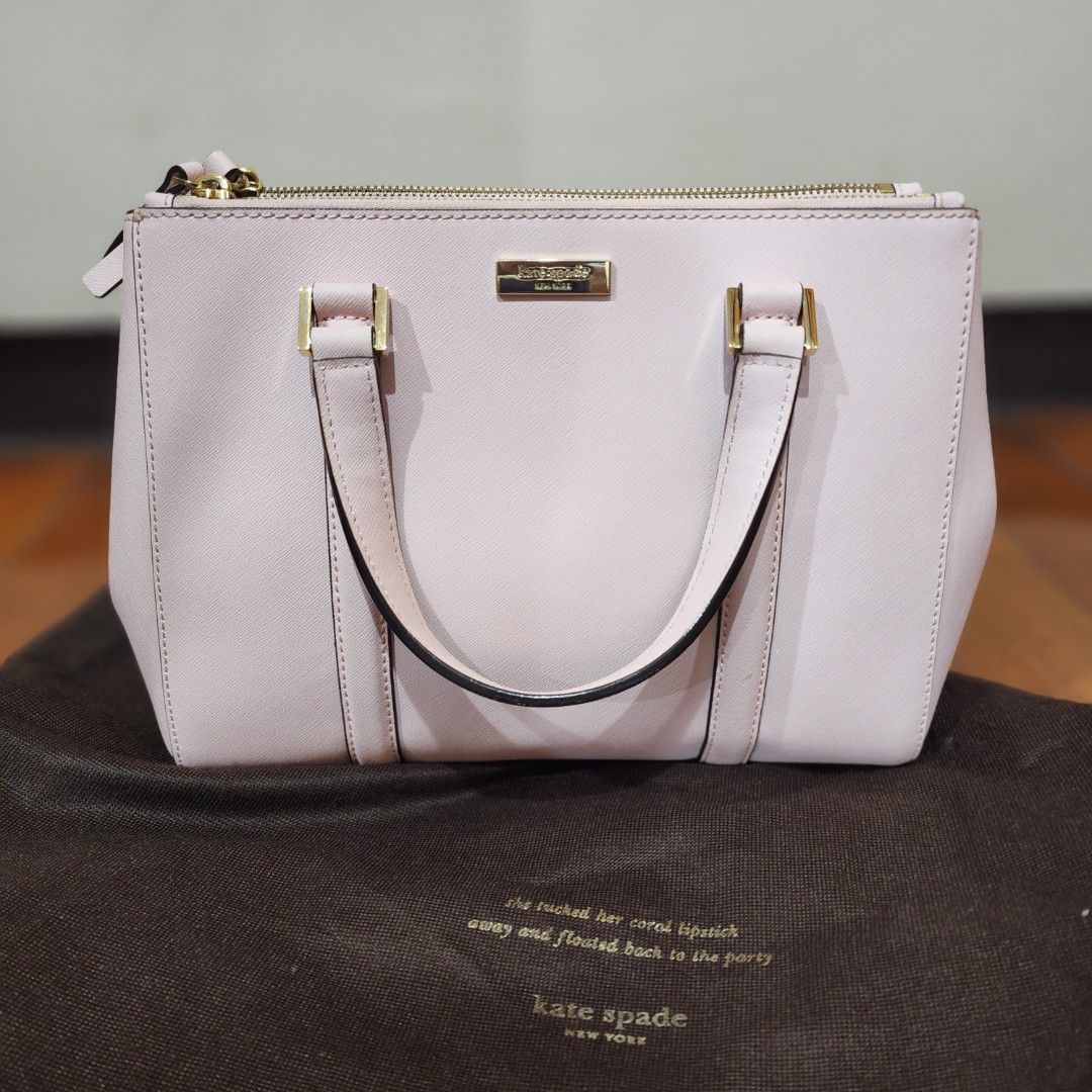 Kate Spade Pink Saffiano Leather Tote Bag (Category: Tote Bags) located in Manila. Submitted by windelynon66264 (Listing ID 1469030021, Image 1). Description: - Brand: Kate Spade - Style: Structured handbag / Satchel - Material: Premium saffiano leather - Color: Light pink with gold-tone hardware - Features: Metal plaque logo, protective bottom feet, dual top handles, secure zip closure compartments - Interior: Stylish black and white patterned l