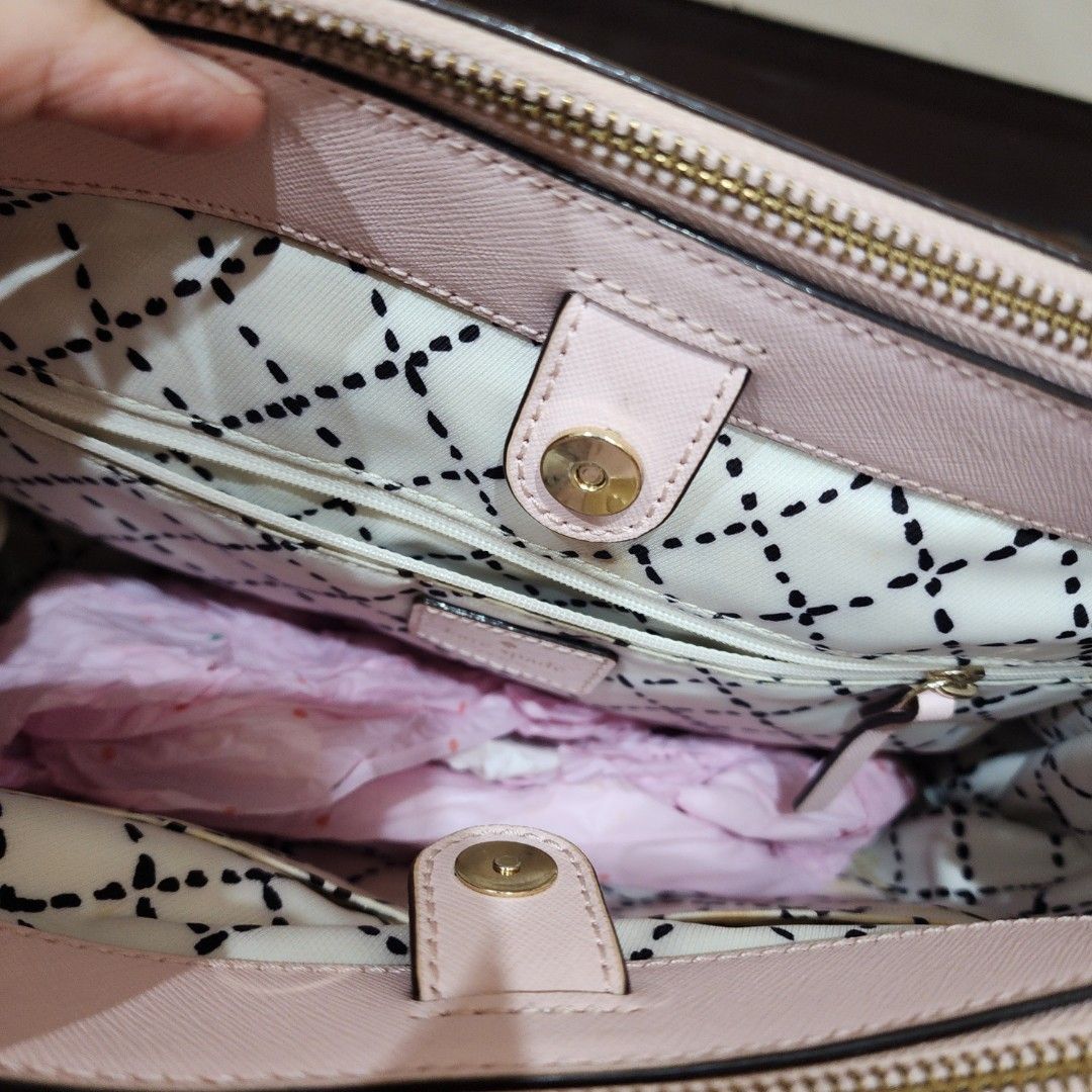 Kate Spade Pink Saffiano Leather Tote Bag (Category: Tote Bags) located in Manila. Submitted by windelynon66264 (Listing ID 1469030021, Image 3). Description: - Brand: Kate Spade - Style: Structured handbag / Satchel - Material: Premium saffiano leather - Color: Light pink with gold-tone hardware - Features: Metal plaque logo, protective bottom feet, dual top handles, secure zip closure compartments - Interior: Stylish black and white patterned l