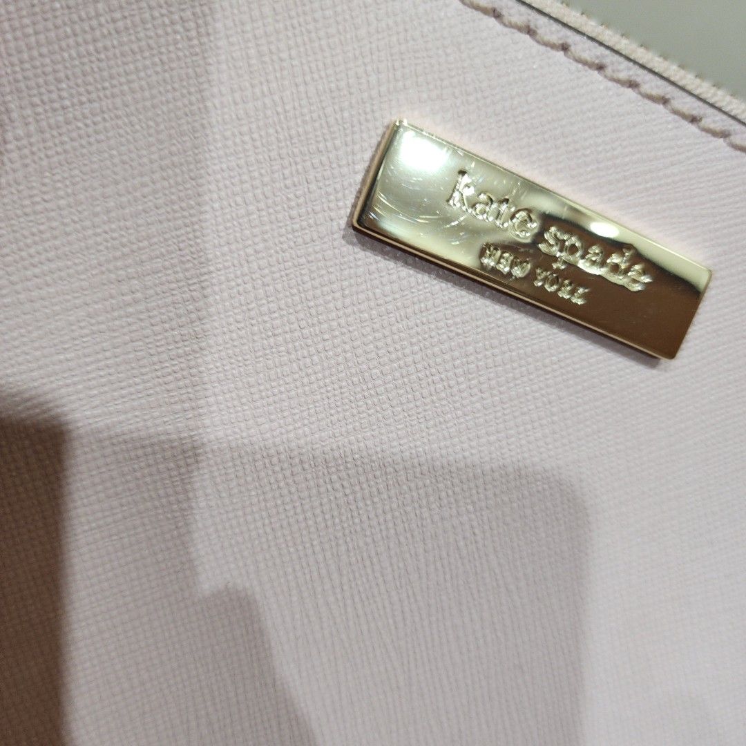 Kate Spade Pink Saffiano Leather Tote Bag (Category: Tote Bags) located in Manila. Submitted by windelynon66264 (Listing ID 1469030021, Image 2). Description: - Brand: Kate Spade - Style: Structured handbag / Satchel - Material: Premium saffiano leather - Color: Light pink with gold-tone hardware - Features: Metal plaque logo, protective bottom feet, dual top handles, secure zip closure compartments - Interior: Stylish black and white patterned l