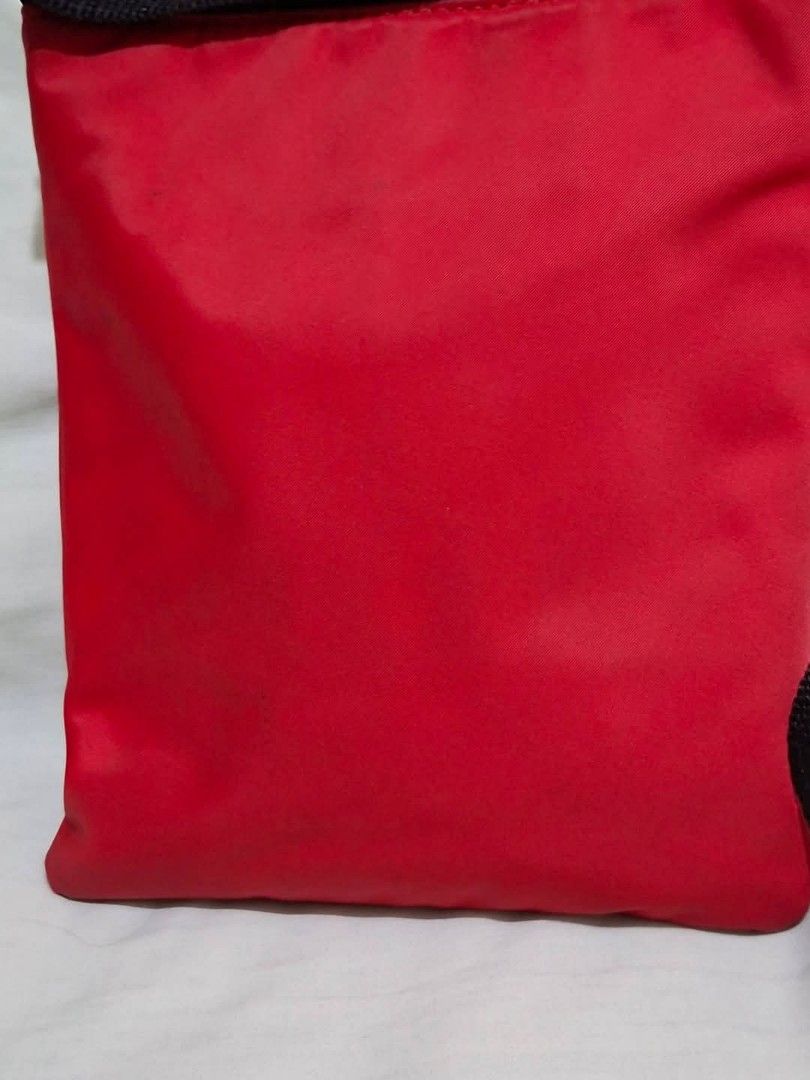 Kate Spade Red Nylon Crossbody Bag (Category: Cross-body Bags) located in Manila. Submitted by closetprincess (Listing ID 1468959378, Image 3). Description: - Brand: Kate Spade - Color: Vibrant red nylon with black straps and hardware - Closure: Secure zip-top closure - Pockets: Convenient front exterior zipped pocket for quick-access items - Strap: Adjustable black webbing strap for shoulder or crossbody wear - Design: Compact, classic rectangul