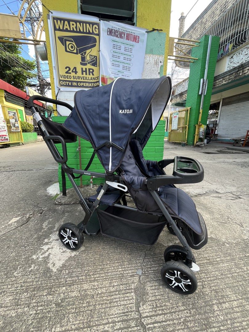 Katoji Double Stroller Navy Blue Foldable (Category: Strollers) located in Manila. Submitted by batusaipus03057 (Listing ID 1468990240, Image 3). Description: ❤️Katoji Two-Seater / Sit-and-Stand Tandem Stroller❤️ Key Features & Specifications • Design: Tandem 2-seater stroller with a front reclining seat and a rear sit-and-stand platform/seat. • Age & Weight Limits: • Front Seat: Suitable from 4/6 months up to 20 kg (44.1 lbs) with 3-level reclin