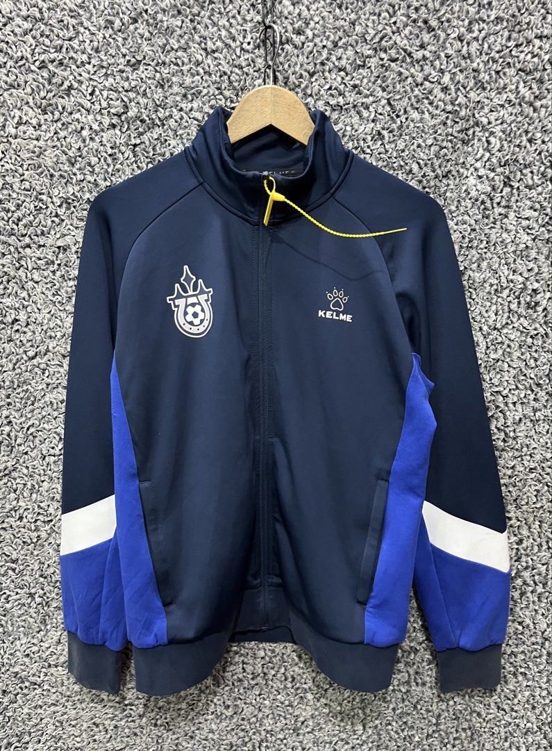 Kelme Track Jacket | Size M (Category: Coats, Jackets and Outerwear) located in General Trias. Submitted by zrchustle.604 (Listing ID 1469074004, Image 1). Description: Kelme Track Jacket (Model 8061WT1007.9428) in a dark navy blue, royal blue, and white colorway. It is constructed from a lightweight polyester and cotton blend fabric tailored for training, soccer, or casual athleisure wear..