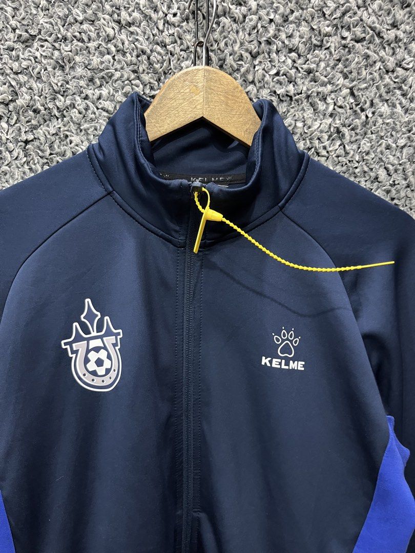 Kelme Track Jacket | Size M (Category: Coats, Jackets and Outerwear) located in General Trias. Submitted by zrchustle.604 (Listing ID 1469074004, Image 2). Description: Kelme Track Jacket (Model 8061WT1007.9428) in a dark navy blue, royal blue, and white colorway. It is constructed from a lightweight polyester and cotton blend fabric tailored for training, soccer, or casual athleisure wear..