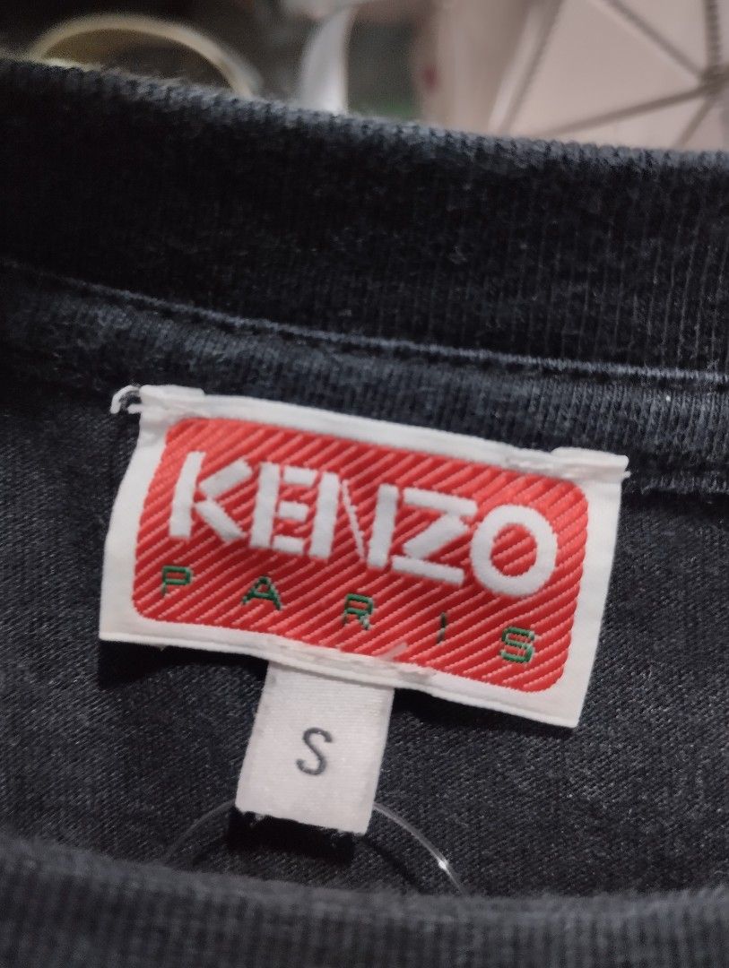 Kenzo Paris Black Flower Tee (Category: Tshirts & Polo Shirts ) located in Manila. Submitted by niggzreyno51476 (Listing ID 1469086548, Image 3). Description: - Brand: Kenzo Paris - Color: Black with red and white chest graphic - Size: S - Material: 100% Cotton - Origin: Made in Portugal - Condition: Authentic with tags and care labels attached - Style: Classic crew neck, short sleeves, casual staple.