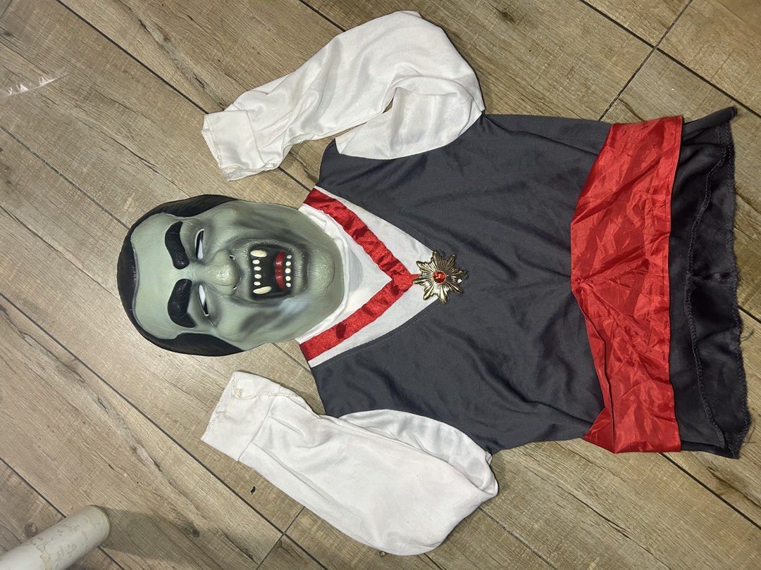 Kids count dracula Vampire Costume (Category: Babies & Kids Fashion) located in Paranaque City. Submitted by zac.sei (Listing ID 1468899471, Image 2). Description: - Vampire costume including top and matching mask - Gray vest-style front with white sleeves and attached red sash - Gold-tone decorative medallion pin with red gem at the neckline - Elastic band on the back of the mask for easy wearing.