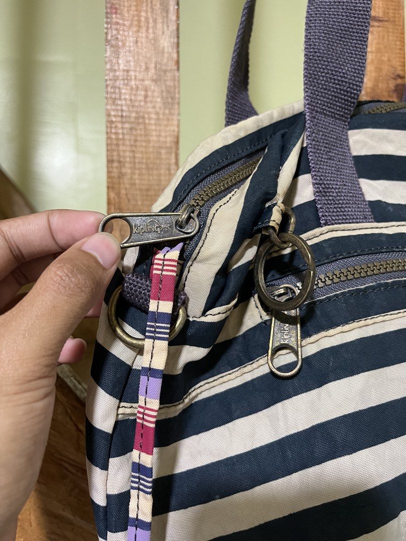 Kipling Black and Beige Striped Tote Bag (Category: Tote Bags) located in Carmen, Agusan del Norte. Submitted by all.en.thrifts (Listing ID 1469102542, Image 2). Description: - Brand: Kipling - Design: Classic black and beige stripes with front logo patch - Material: Durable, lightweight nylon - Compartments: Secure main zipped closure with vibrant light green inner lining - Pockets: Front zipped pocket and multiple inner pockets for easy organiz
