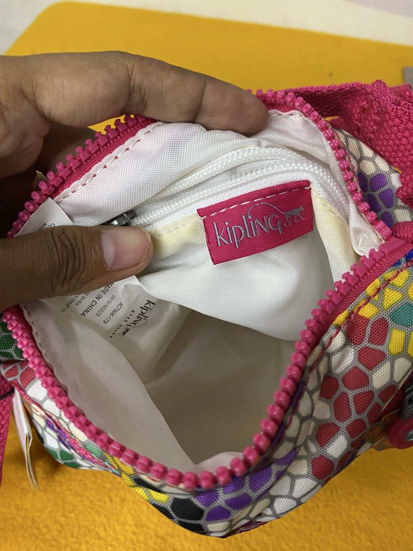 Kipling Keiko Spellbinder Multi-Colored Mosaic Crossbody Bag (Category: Cross-body Bags) located in Manila. Submitted by onfleekapparelph (Listing ID 1469067758, Image 3). Description: - Brand: Kipling Keiko Crossbody Bag - Print/Color: Spellbinder mosaic multi-colored pattern with a pink adjustable strap - Compartments: Secure top main zipper compartment and two handy front zip pockets - Interior: Clean white fabric lining - Extras: Includes ori