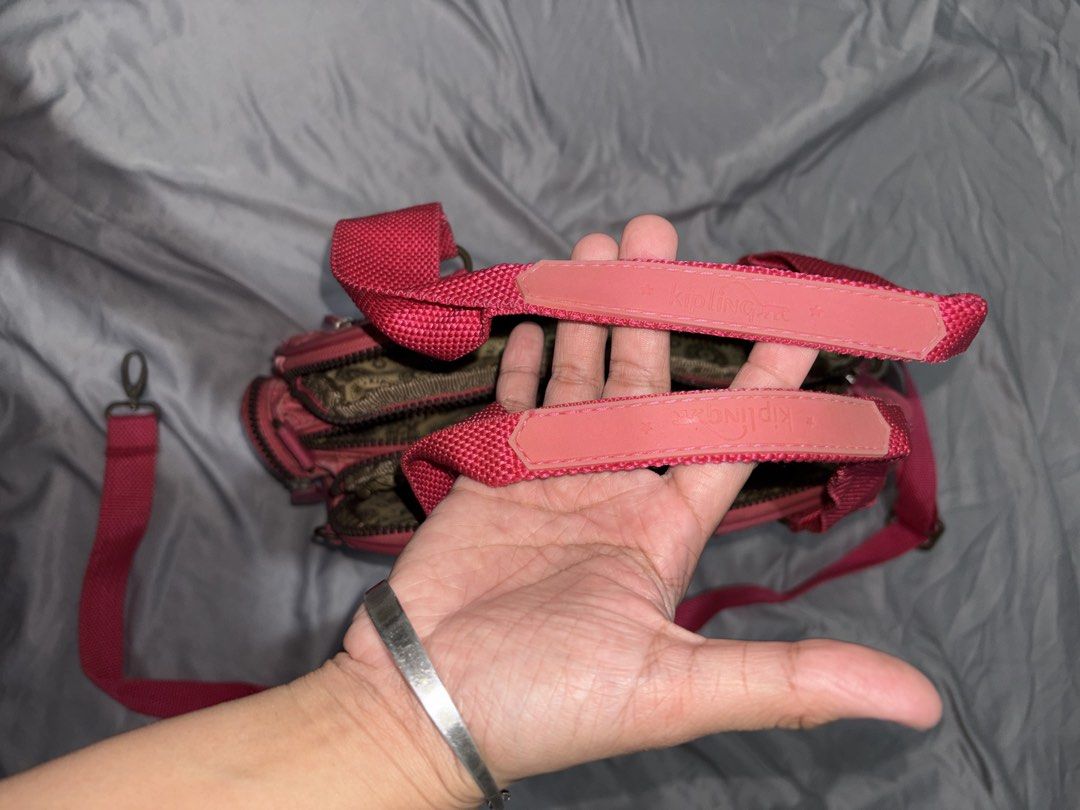Kipling pastel red bag (Category: Shoulder Bags) located in Taguig. Submitted by aliuy (Listing ID 1469102398, Image 3). Description: Authentic Kipling bag Rfs: decluttering Zipper is medyo maganit but working ▪️Shipping via J&T or Grab Express/Lalamove for MNL area; J&T for provinces ▪️No Shope.e checkout ▪️Location of item: Taguig ▪️Available as long as posted ▪️Last price as posted ▪️Not interested in swapping ▪️ Will hold reserved items for 2