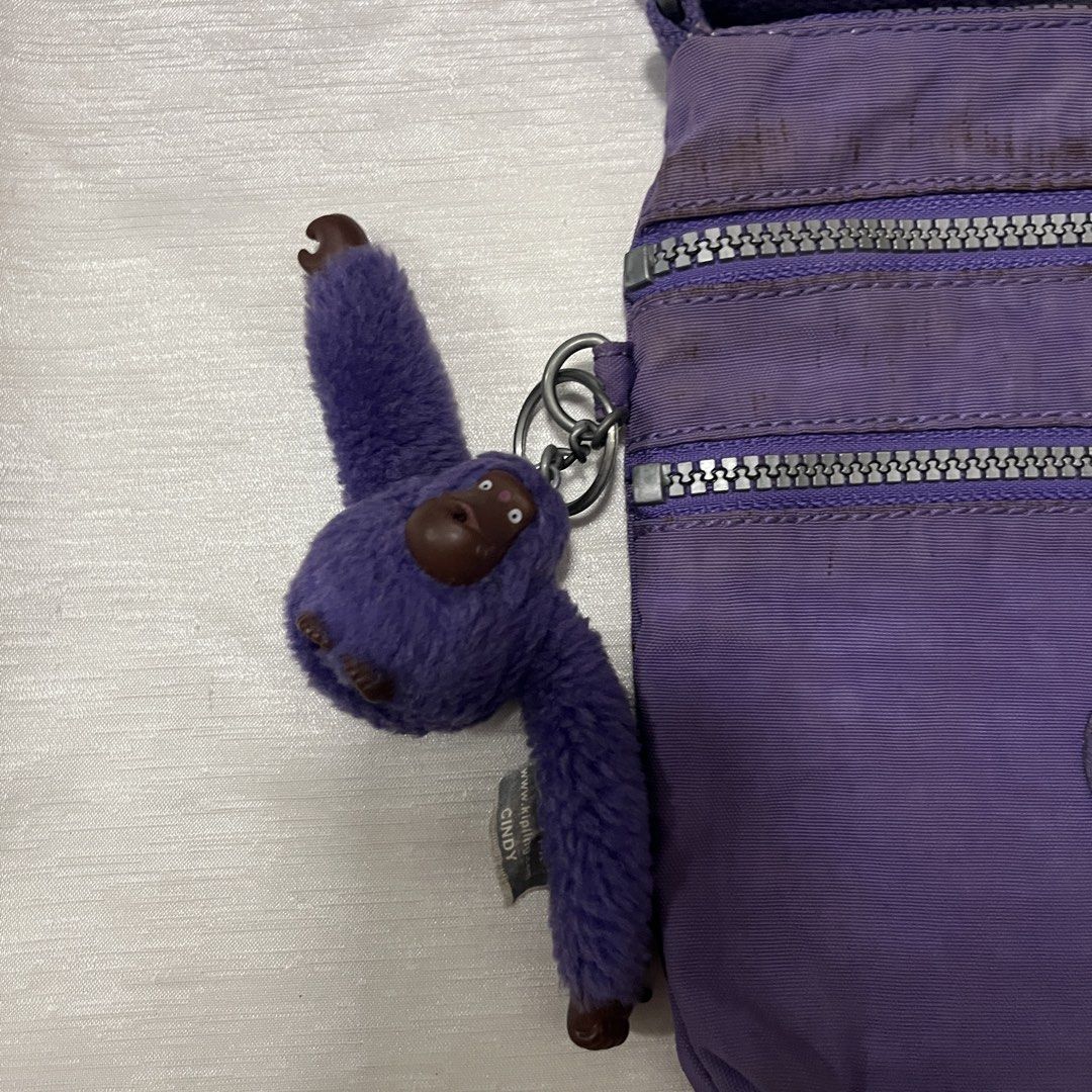 Kipling Purple Crossbody Bag with Cindy Monkey Keychain (Category: Cross-body Bags) located in Dasmarinas. Submitted by minx203 (Listing ID 1469024596, Image 2). Description: - Authentic Kipling crossbody bag in a stylish purple shade - Crafted from durable, lightweight nylon - Includes the adorable Cindy fuzzy monkey keychain - Multiple front zippered compartments for easy organization - Adjustable strap for comfortable shoulder or crossbody wea