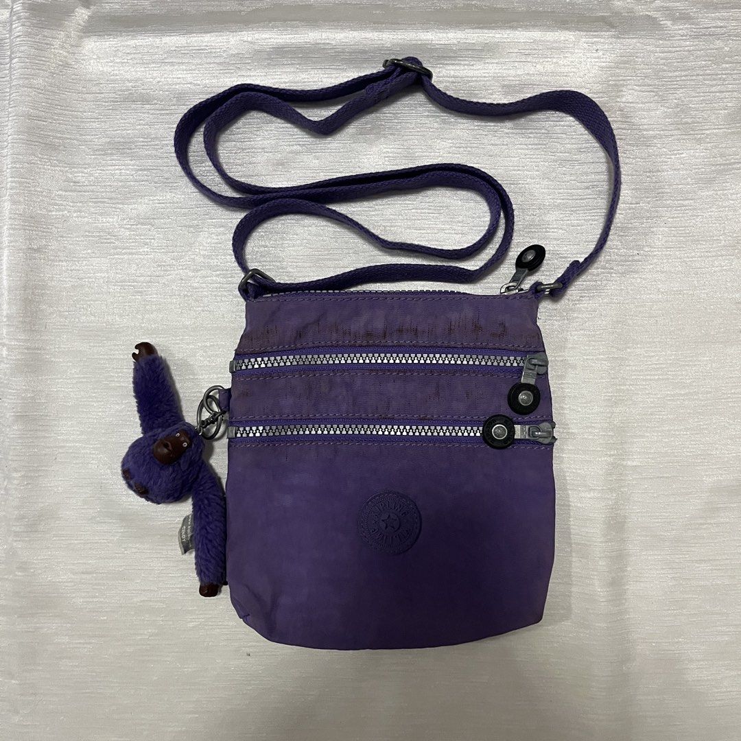 Kipling Purple Crossbody Bag with Cindy Monkey Keychain (Category: Cross-body Bags) located in Dasmarinas. Submitted by minx203 (Listing ID 1469024596, Image 1). Description: - Authentic Kipling crossbody bag in a stylish purple shade - Crafted from durable, lightweight nylon - Includes the adorable Cindy fuzzy monkey keychain - Multiple front zippered compartments for easy organization - Adjustable strap for comfortable shoulder or crossbody wea