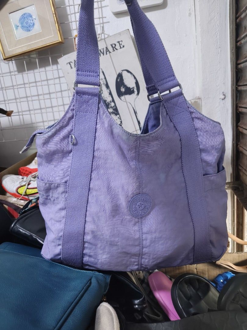 Kipling Purple Tote Shoulder Bag (Category: Tote Bags) located in Binan City. Submitted by makinpeso0622 (Listing ID 1468985861, Image 1). Description: - Authentic Kipling tote bag in a gorgeous light purple shade - Roomy interior, perfect for daily use, work, or school - Secure top zipper closure to keep your belongings safe - Sturdy shoulder straps for comfortable carrying - Convenient exterior side pockets for easy access - Inside features a z