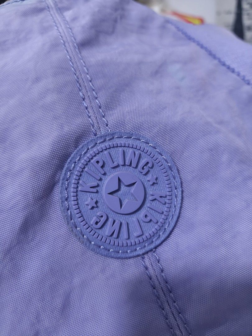 Kipling Purple Tote Shoulder Bag (Category: Tote Bags) located in Binan City. Submitted by makinpeso0622 (Listing ID 1468985861, Image 2). Description: - Authentic Kipling tote bag in a gorgeous light purple shade - Roomy interior, perfect for daily use, work, or school - Secure top zipper closure to keep your belongings safe - Sturdy shoulder straps for comfortable carrying - Convenient exterior side pockets for easy access - Inside features a z