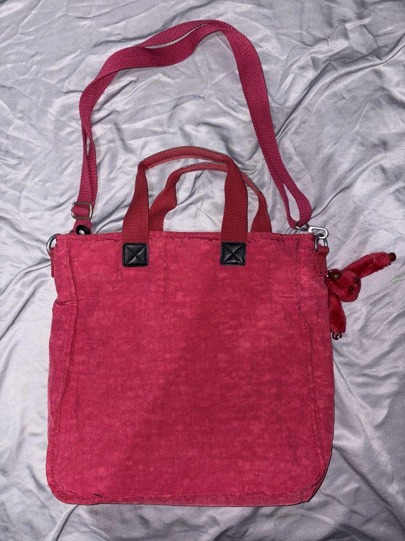 Kipling red bag (Category: Tote Bags) located in Taguig. Submitted by aliuy (Listing ID 1469103476, Image 2). Description: Nice as school or office bag, has pockets for pens and other knick knacks Approximate strap length (inches): - min: 27 - max: 52.5 Authentic Kipling bag Rfs: decluttering ▪️Shipping via J&T or Grab Express/Lalamove for MNL area; J&T for provinces ▪️No Shope.e checkout ▪️Location of item: Taguig ▪️Available as long as posted ▪