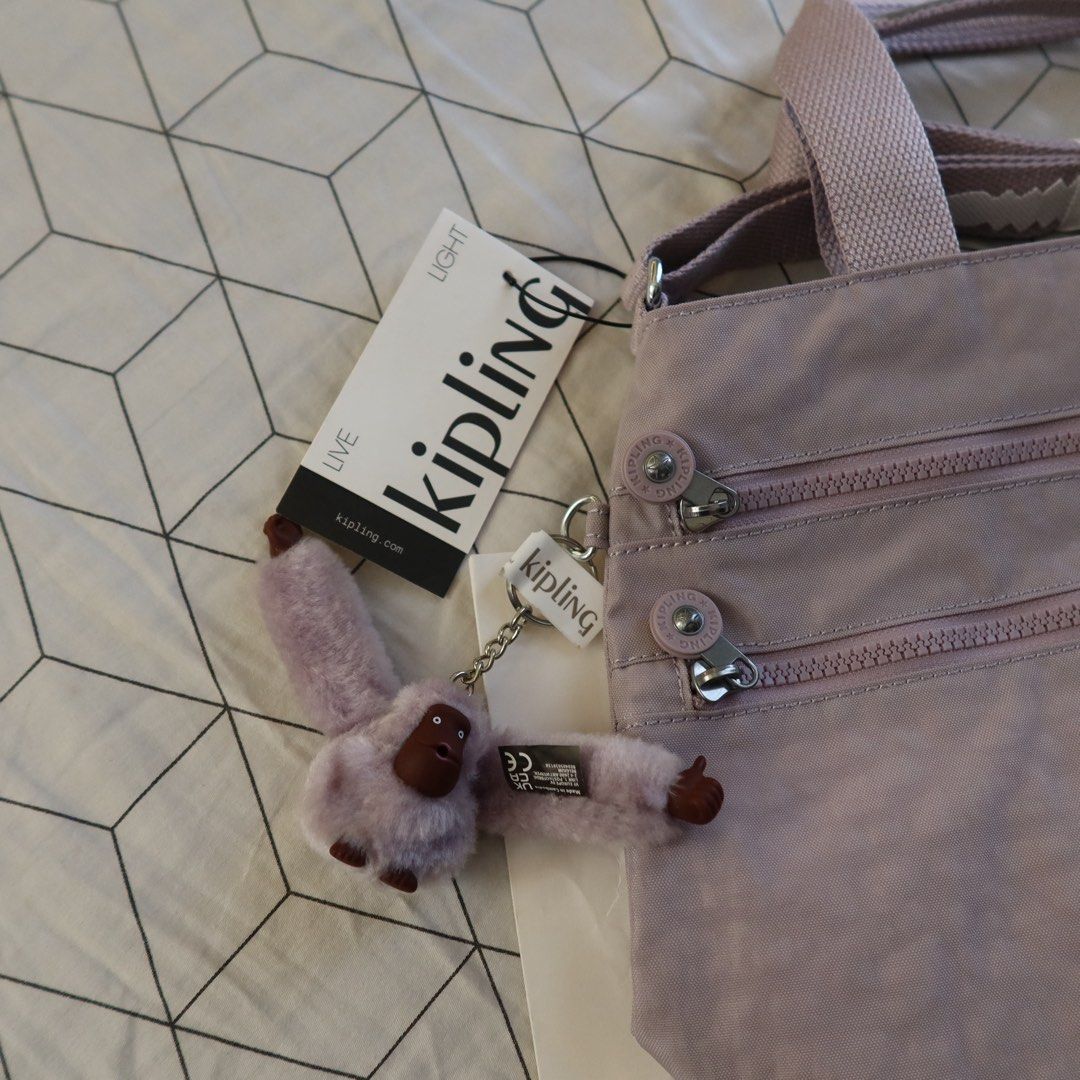 Kipling Serene Lavendar Miah (Category: Shoulder Bags) located in Manila. Submitted by gentlewind_62f064 (Listing ID 1468942521, Image 2). Description: - Brand: Kipling Miah - Colorway: Serene Lavender (Style KI9462 9QR) - Condition: Brand new with tags attached, in original plastic wrapper - Inclusions: Original brand shopping bag and signature furry monkey keychain - Features: Dual top handles and multiple exterior zippered compartments - Retai