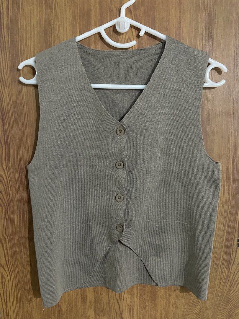 Knitted v-neck button-down vest in taupe (Category: Sleeveless) located in Caloocan City. Submitted by lovedbyryu (Listing ID 1469057886, Image 1). Description: - Color: Taupe - Style: V-neck knit sweater vest with front button closure - Details: 4 brown buttons, ribbed texture, curved hemline, two front pockets - Fit: Sleeveless design, ideal for layering over your favorite shirts - Condition: Brand new/Excellent quality.