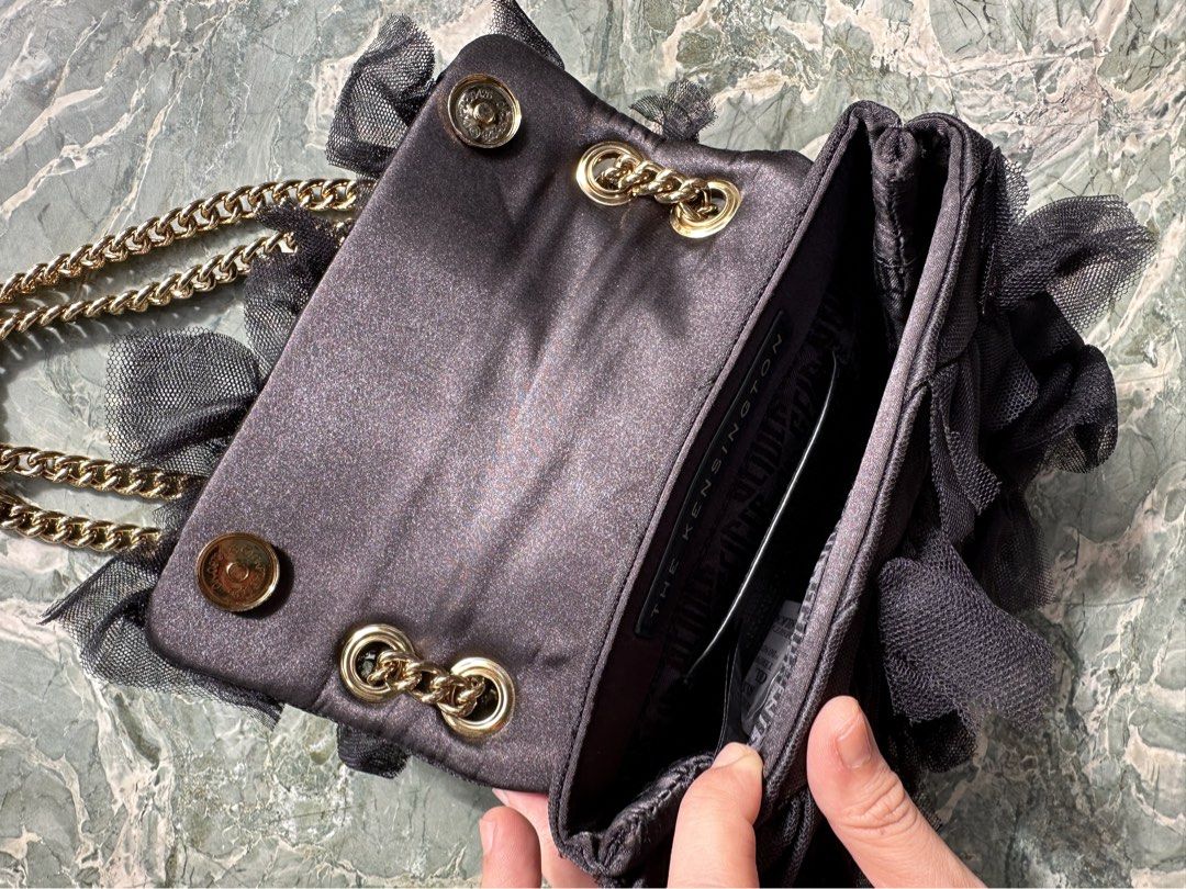 Kurt Geiger London (Category: Shoulder Bags) located in Manila. Submitted by izzzzasclutter (Listing ID 1469099239, Image 3). Description: - Brand: Kurt Geiger London - Style: Kensington Bag - Color: Black with tulle ruffles - Hardware: Gold-tone chain strap - Closure: Crystal-embellished eagle head with magnetic snap flap - Interior: Fabric-lined with slip pocket - Inclusion: Matching black dust bag with graphic print lettering - Condition: Grea