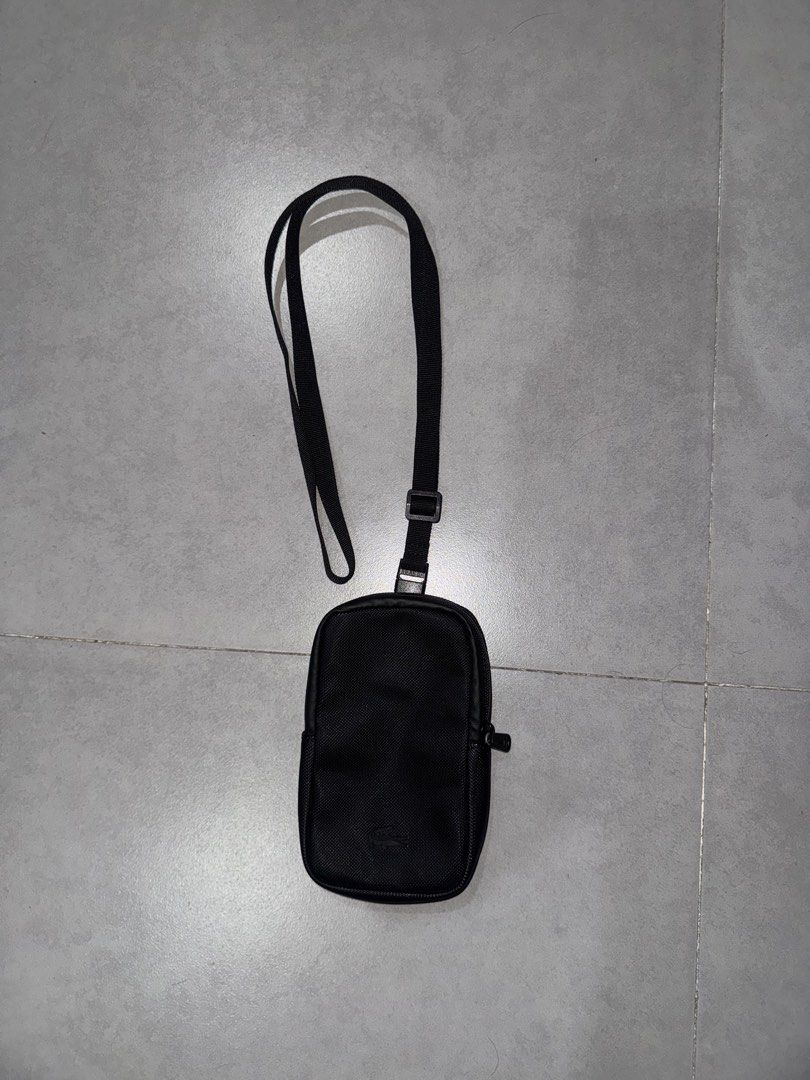 Lacoste Black Crossbody Sling Bag (Category: Sling Bags) located in Caloocan City. Submitted by gabbieerfritter (Listing ID 1469032039, Image 1). Description: - Authentic Black Lacoste Crossbody Bag - Durable textured PVC material with matching care tag - Secure zip closure featuring an embossed crocodile logo pull - Adjustable strap for a comfortable, custom fit - Vibrant green fabric interior lining with classic Lacoste logo patch - Compact and