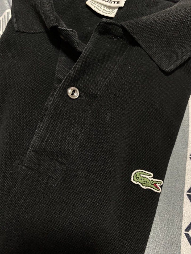 Lacoste Black Polo Shirt Size 5 Devanlay (Category: Tshirts & Polo Shirts ) located in Taguig. Submitted by maaarrrrrcky (Listing ID 1469069499, Image 3). Description: - Brand: Lacoste - Color: Black - Size: 5 (Regular Fit) - Material: Cotton petit piqué - Details: Classic two-button placket with mother-of-pearl buttons, iconic embroidered green crocodile logo - Origin: Designed in France, made in El Salvador by Devanlay - Condition: Clean collar