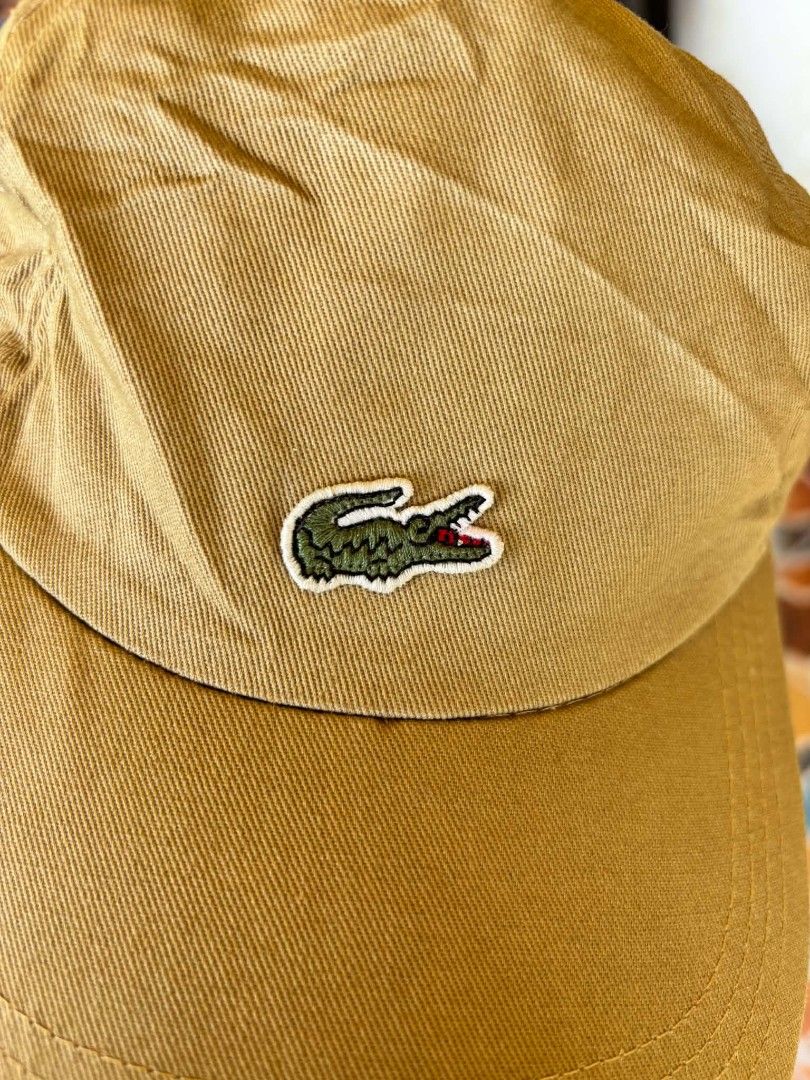 Lacoste khaki baseball cap (Category: Caps & Hats) located in Cuartero. Submitted by tripthriftfinds (Listing ID 1468962745, Image 2). Description: - Brand: Lacoste - Color: Khaki - Material: 100% Cotton - Design: Classic 6-panel construction with embroidered eyelets - Logo: Iconic embroidered crocodile on the front - Closure: Adjustable strap with metal slider and small woven Lacoste tag - Condition: Excellent / Brand New - Style: Versatile ever