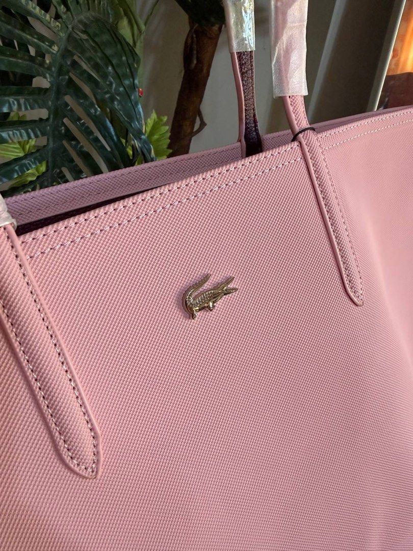 LACOSTE REVERSIBLE TOTE BAG (Category: Shoulder Bags) located in Taguig. Submitted by renzms (Listing ID 1469087940, Image 2). Description: • fresh from 🇻🇳 • with dust bag & extra pouch • on hand & ready to ship • actual photos | what you see is what you exactly get! • shipping nationwide via tiktok co 2 colors: Maroon and Pink.