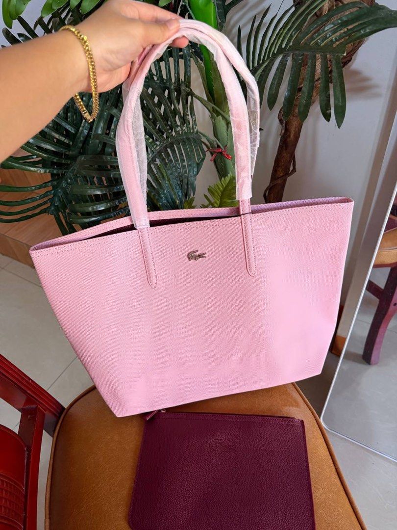 LACOSTE REVERSIBLE TOTE BAG (Category: Shoulder Bags) located in Taguig. Submitted by renzms (Listing ID 1469087940, Image 1). Description: • fresh from 🇻🇳 • with dust bag & extra pouch • on hand & ready to ship • actual photos | what you see is what you exactly get! • shipping nationwide via tiktok co 2 colors: Maroon and Pink.