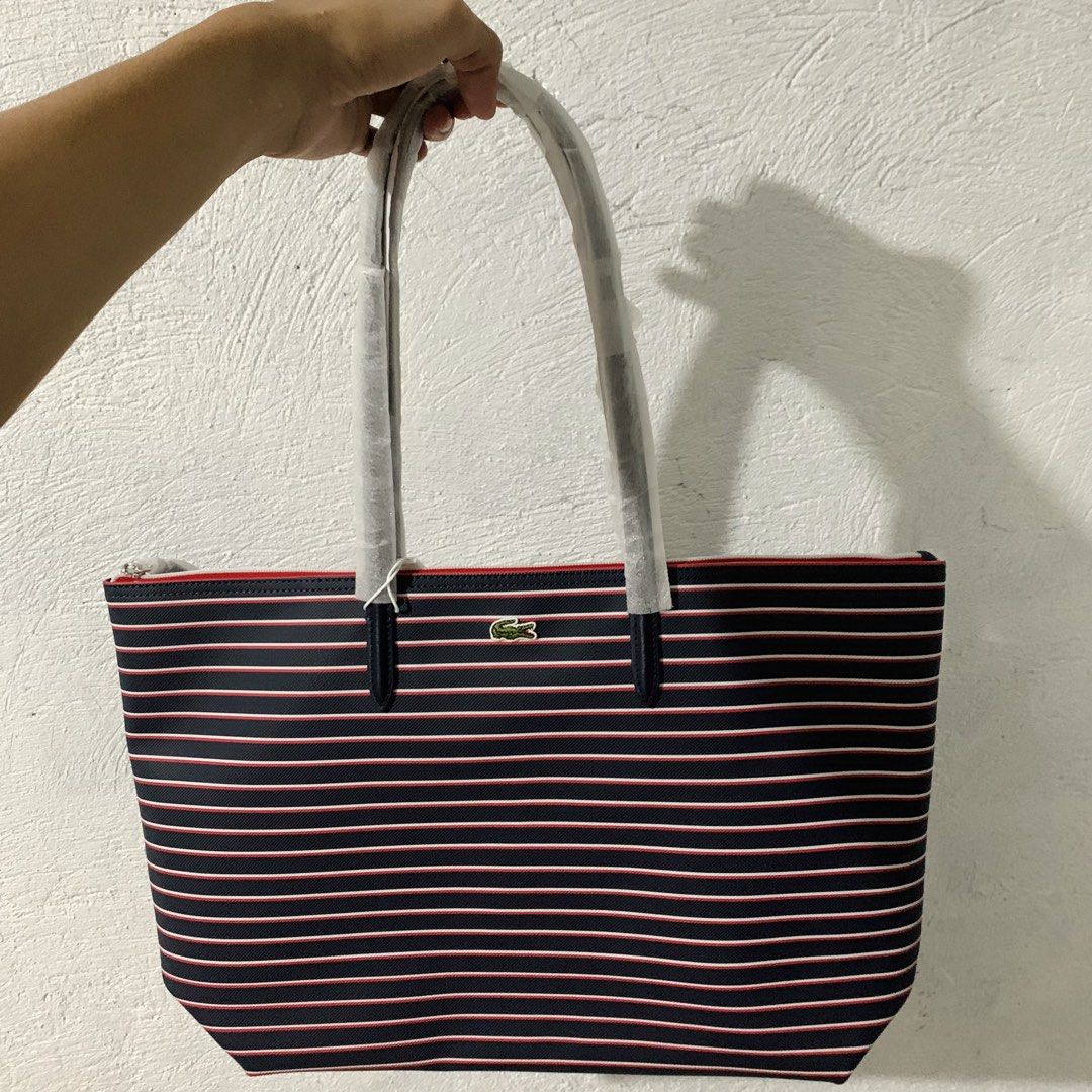Lacoste Stripes Tote Bag (Category: Luxury Bags & Wallets) located in Manila. Submitted by yunotadashi (Listing ID 1469042665, Image 1). Description: ✨ Authentic Lacoste tote bag from the US! 🇺🇸 - Original price was almost ₱8,000 in the Philippines. - Still has the original bag tag and paper cover, but the plastic packaging is no longer available. - Never been used. The bag was originally gifted to my mom. - NO ISSUES❗️ RFS: Need money. 📍 Meet