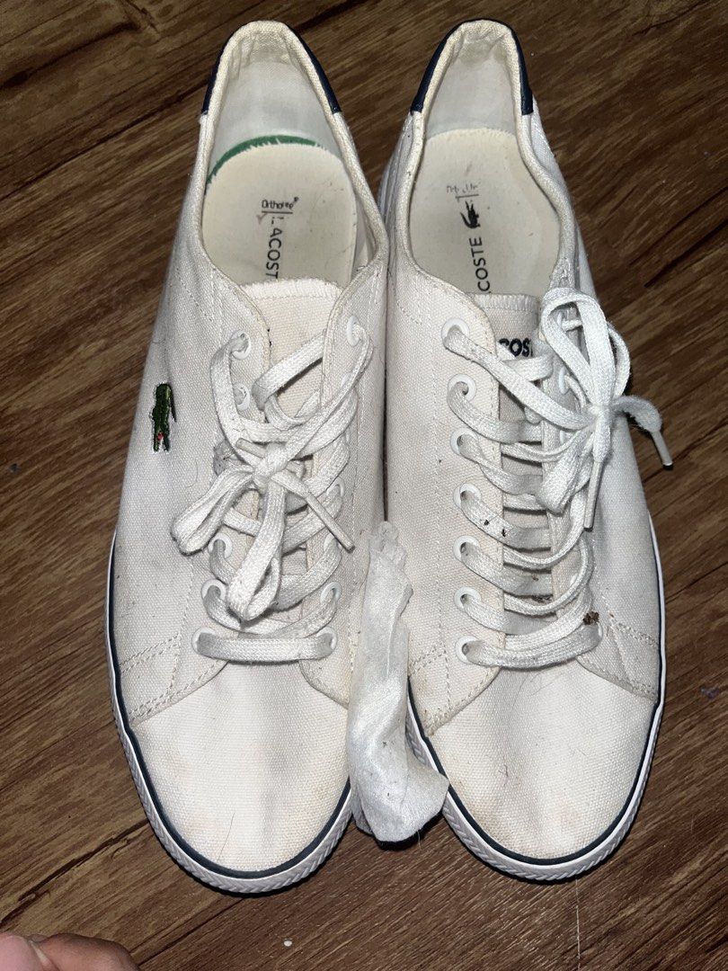Lacoste White Canvas Sneakers (Category: Sneakers) located in San Pablo. Submitted by crazyr17 (Listing ID 1468971000, Image 1). Description: - Brand: Lacoste - Color: White canvas with dark navy heel tabs and green crocodile embroidery - Closure: Traditional lace-up with white laces - Comfort: OrthoLite insoles for all-day wear - Soles: Textured rubber with black and dark navy contrast inserts - Condition: Normal signs of wear on fabric and sole