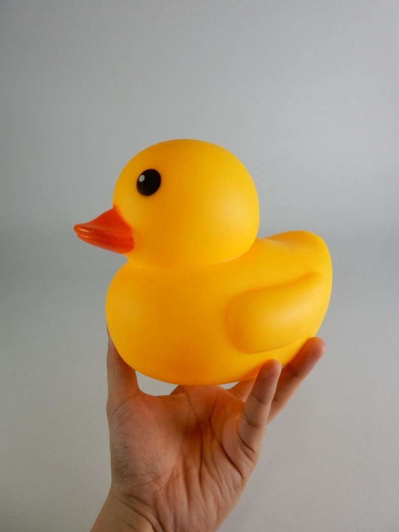 Large Yellow Rubber Duck Bath Toy (Category: Kids Toys) located in Bacoor. Submitted by banananana12 (Listing ID 1469011513, Image 1). Description: - Item: Classic yellow rubber duck bath toy - Color: Bright yellow with an orange bill and black eyes - Condition: Excellent, clean surface with no scuffs or marks - Features: Standard size for tub or pool play with a small central hole at the bottom.