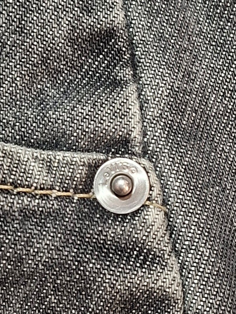 Levi Strauss & Co. Black Denim Jeans (Category: Jeans) located in Baguio. Submitted by restyrille77846 (Listing ID 1468998709, Image 3). Description: - Brand: Levi Strauss & Co. - Color: Classic Black - Closure: Button fly with branded metal buttons - Fit: Straight leg cut with traditional five-pocket styling - Condition: Good pre-loved condition with natural fraying and wear along the bottom hems.