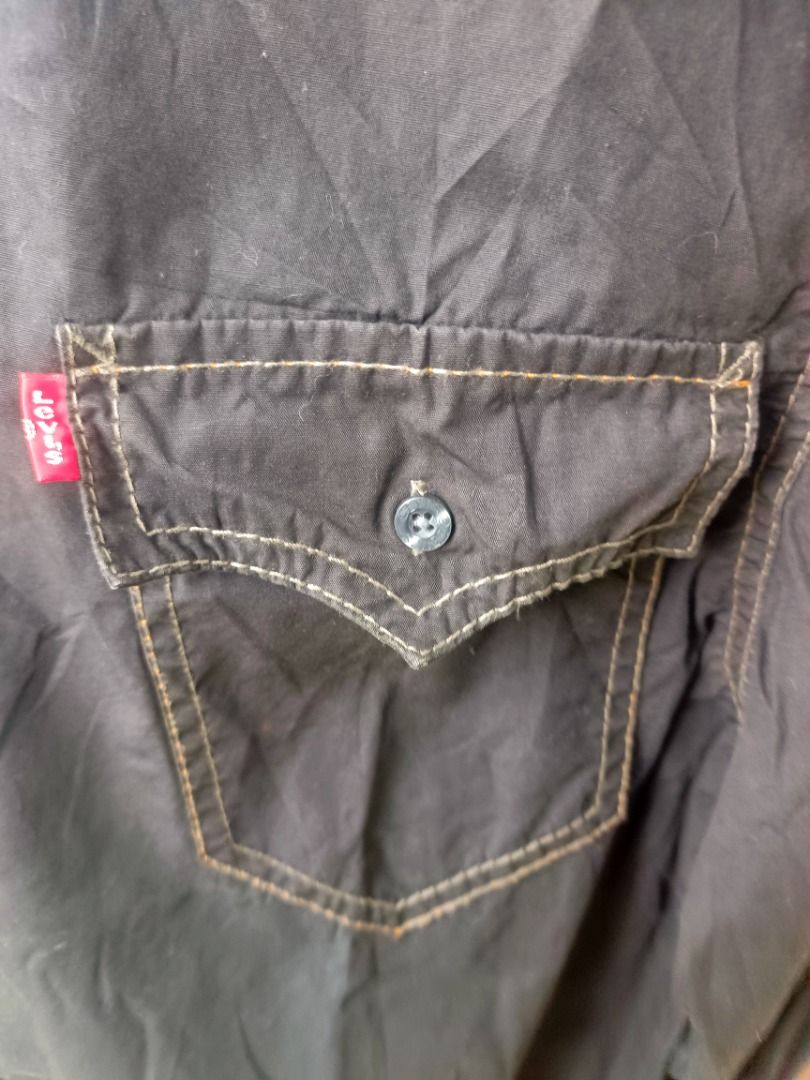 Levi's Black Button-Up (Category: Coats, Jackets and Outerwear) located in Caloocan City. Submitted by jie_theseller17 (Listing ID 1469078711, Image 3). Description: - 2-piece men's casual bundle ready to ship - Piece 1: Levi's black long-sleeve button-up shirt with front chest pockets, contrasting brown inner collar trim, and white contrast stitching - Piece 2: Timberland white short-sleeve crewneck t-shirt with a black woven logo patch on the c
