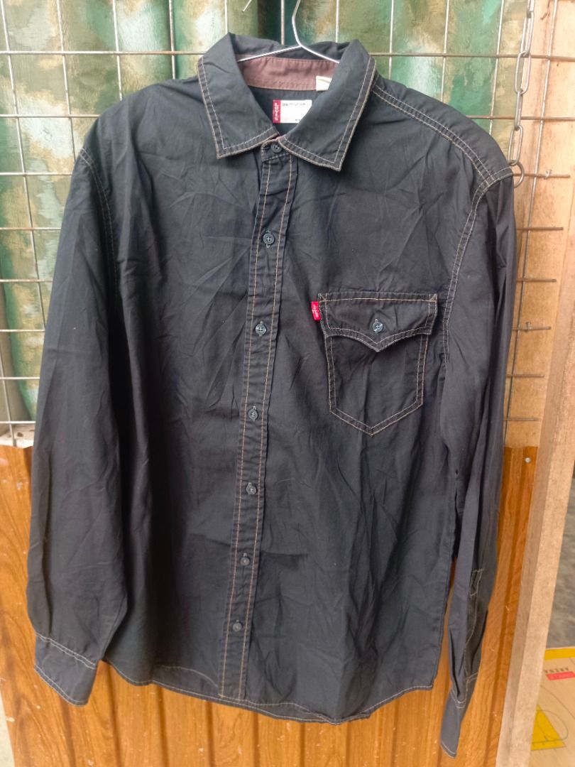 Levi's Black Button-Up (Category: Coats, Jackets and Outerwear) located in Caloocan City. Submitted by jie_theseller17 (Listing ID 1469078711, Image 1). Description: - 2-piece men's casual bundle ready to ship - Piece 1: Levi's black long-sleeve button-up shirt with front chest pockets, contrasting brown inner collar trim, and white contrast stitching - Piece 2: Timberland white short-sleeve crewneck t-shirt with a black woven logo patch on the c